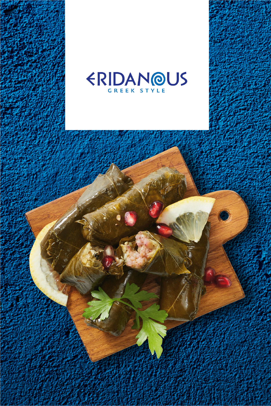 Greek-style stuffed vine leaves (dolmades) with lemon and pomegranate on a wooden board.