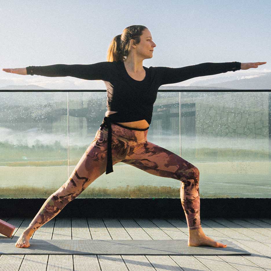 Woman in leggings and yoga top on a terrace